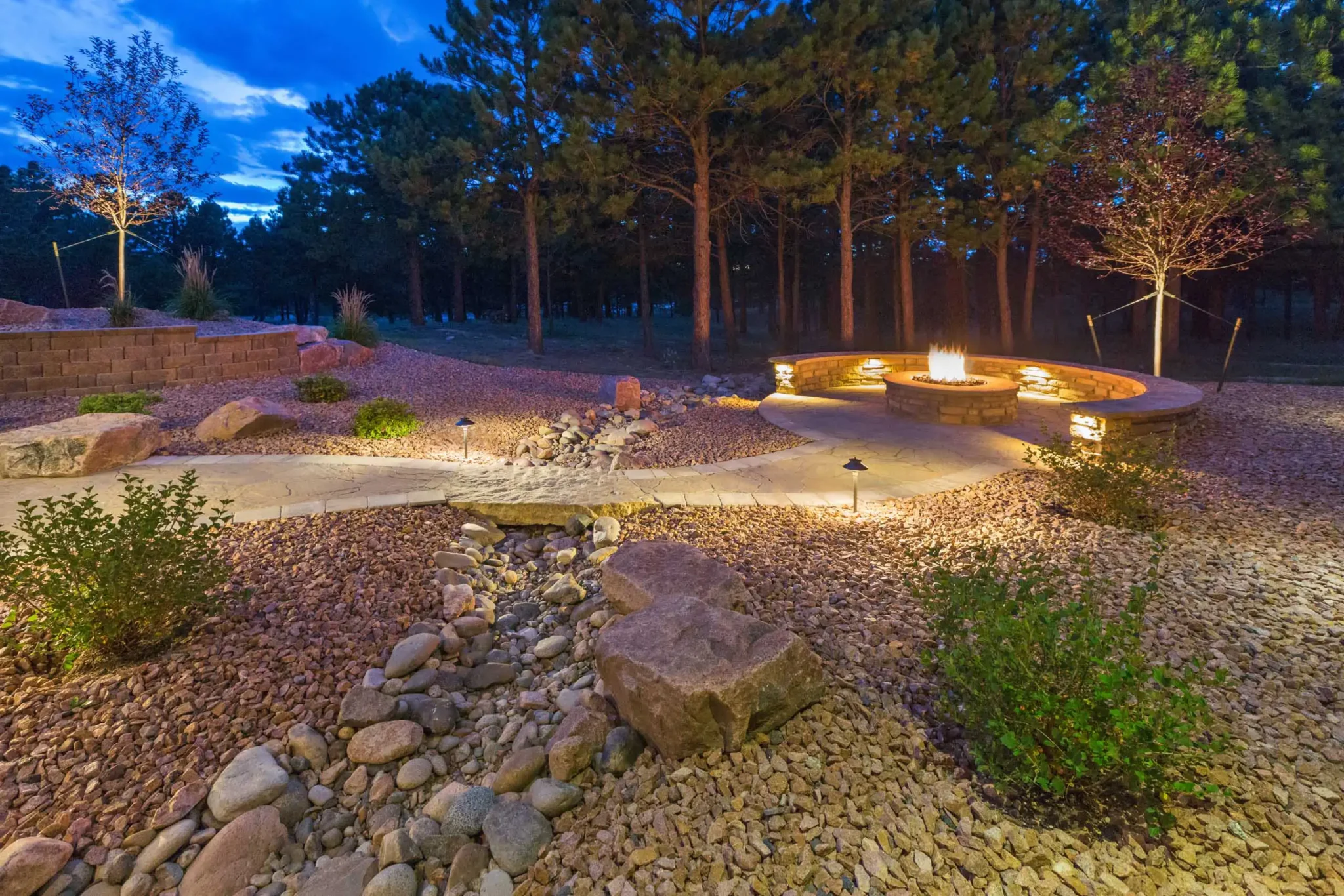Circular fire feature and seat wall within a low-water landscape