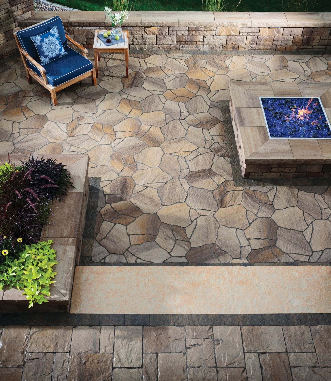 Square fire feature built into a detailed stone patio