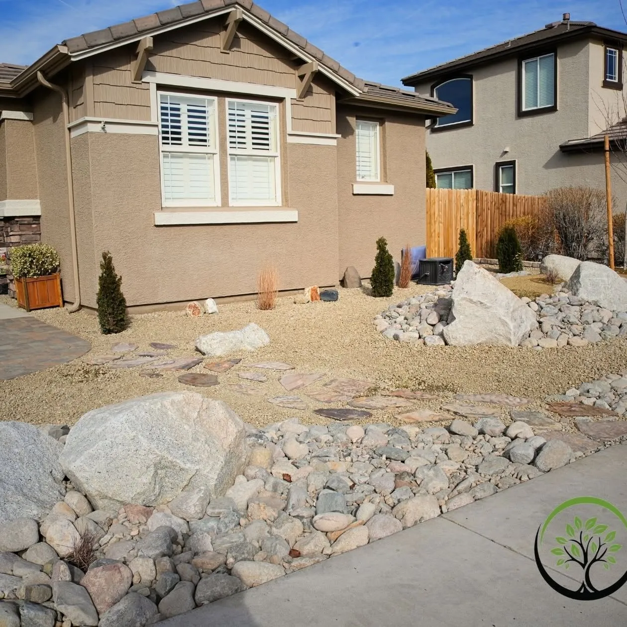 Front-yard transformation with boulders, stone paths, and planting