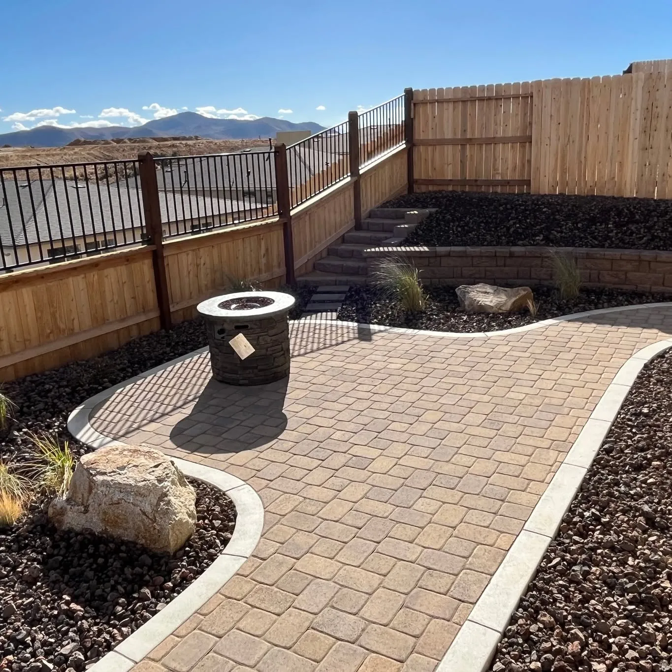 Completed outdoor landscape with coordinated surfaces and planting