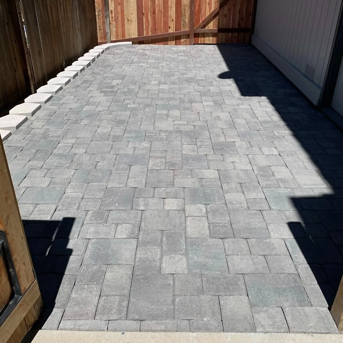 Completed paver walkway beside a residence