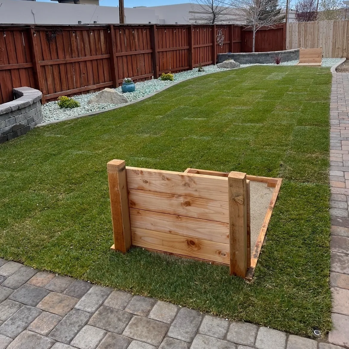 Artificial turf integrated into a low-maintenance yard
