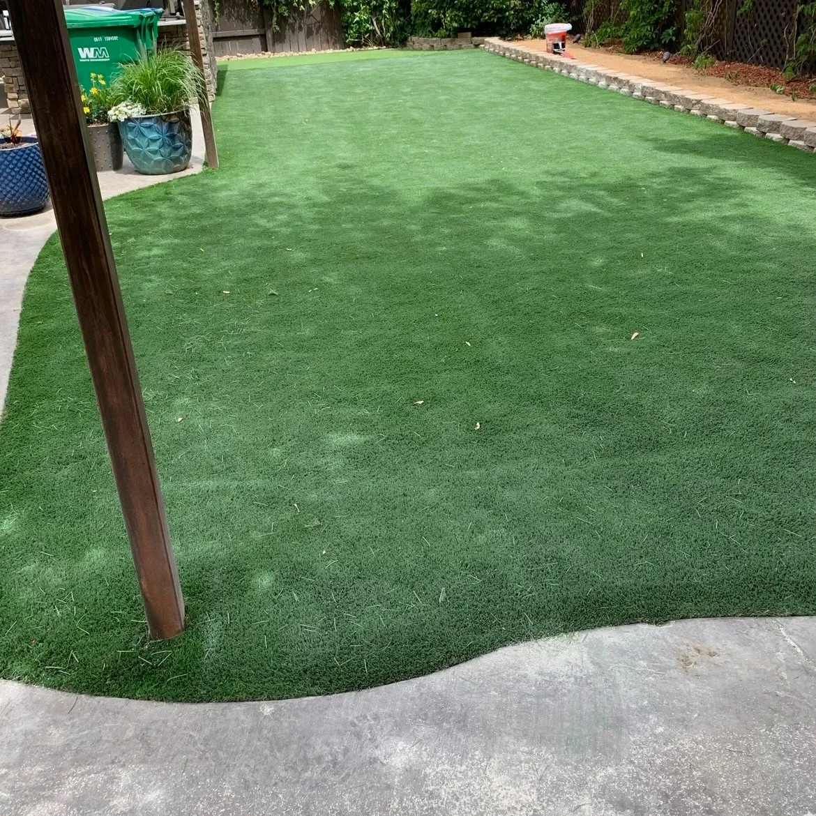 Large artificial-turf recreation area beside hardscape
