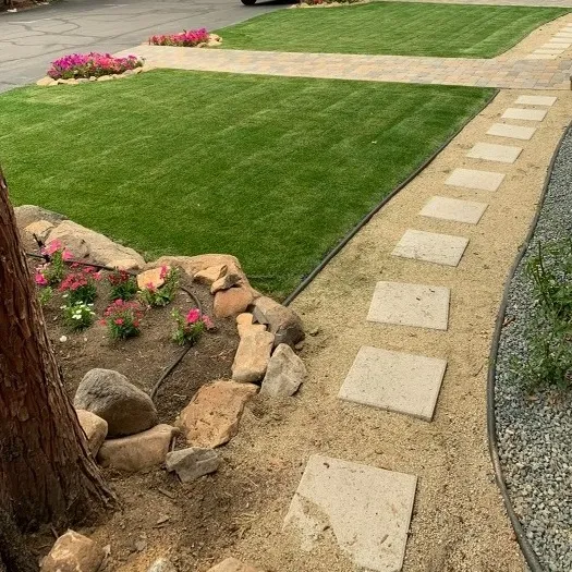 Artificial turf and landscape edging in a finished yard