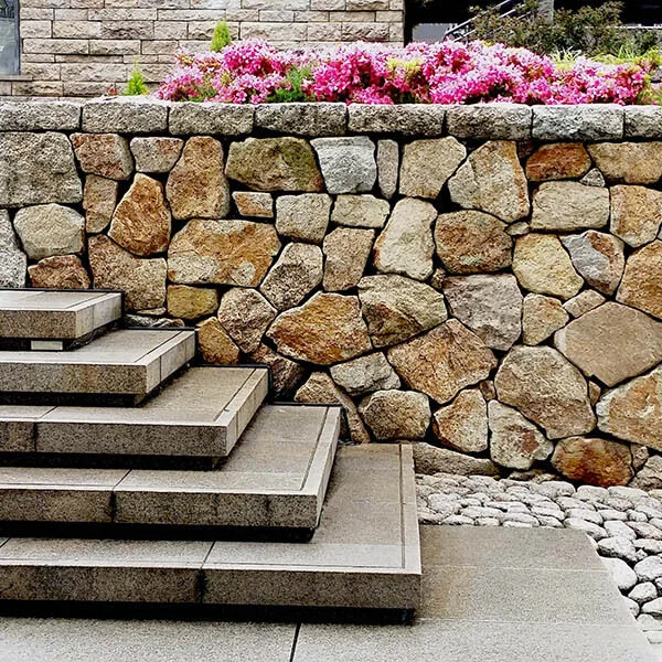 Stone retaining wall beside broad outdoor steps